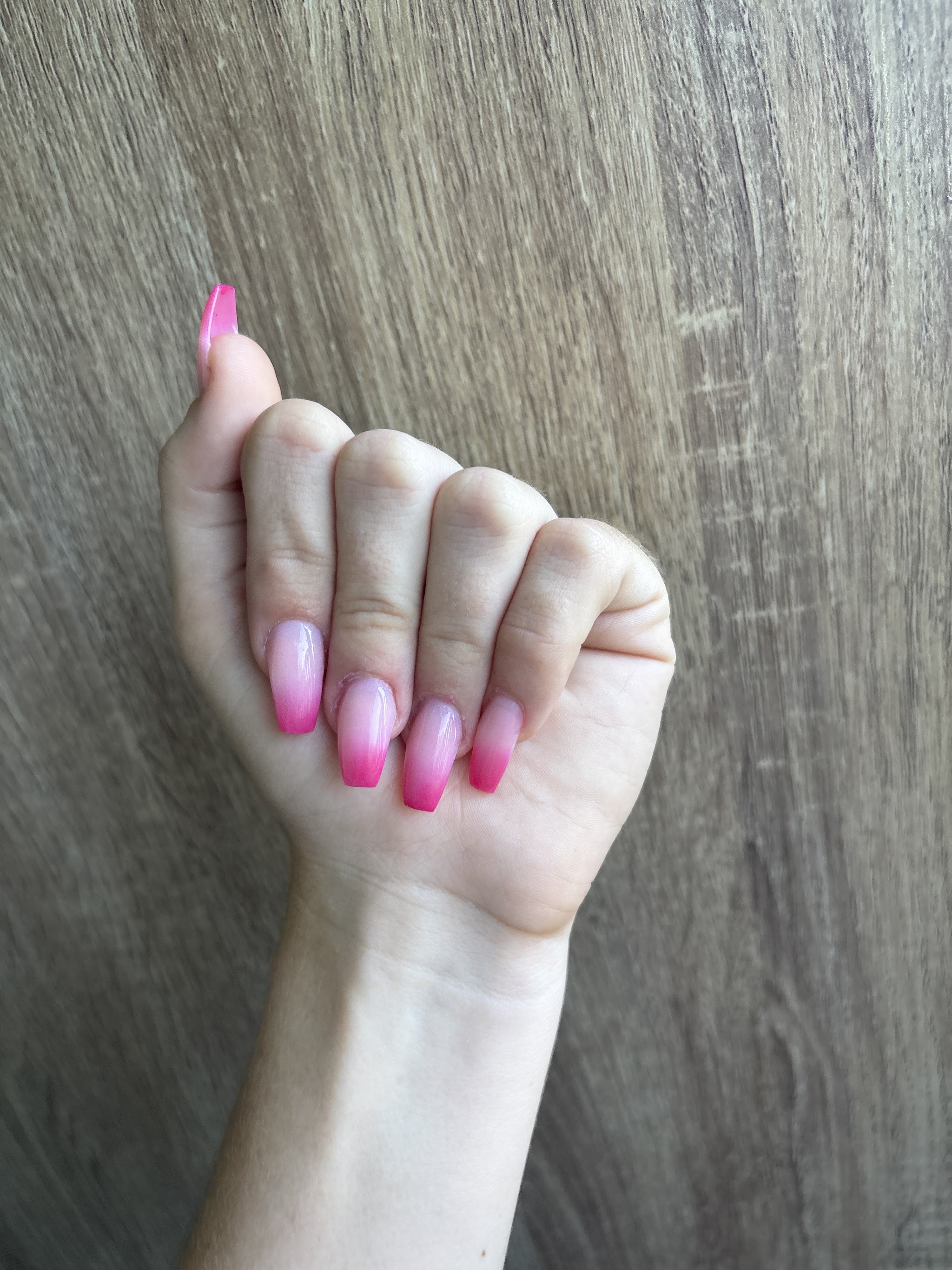 A set of pink ombre nails done at the salon