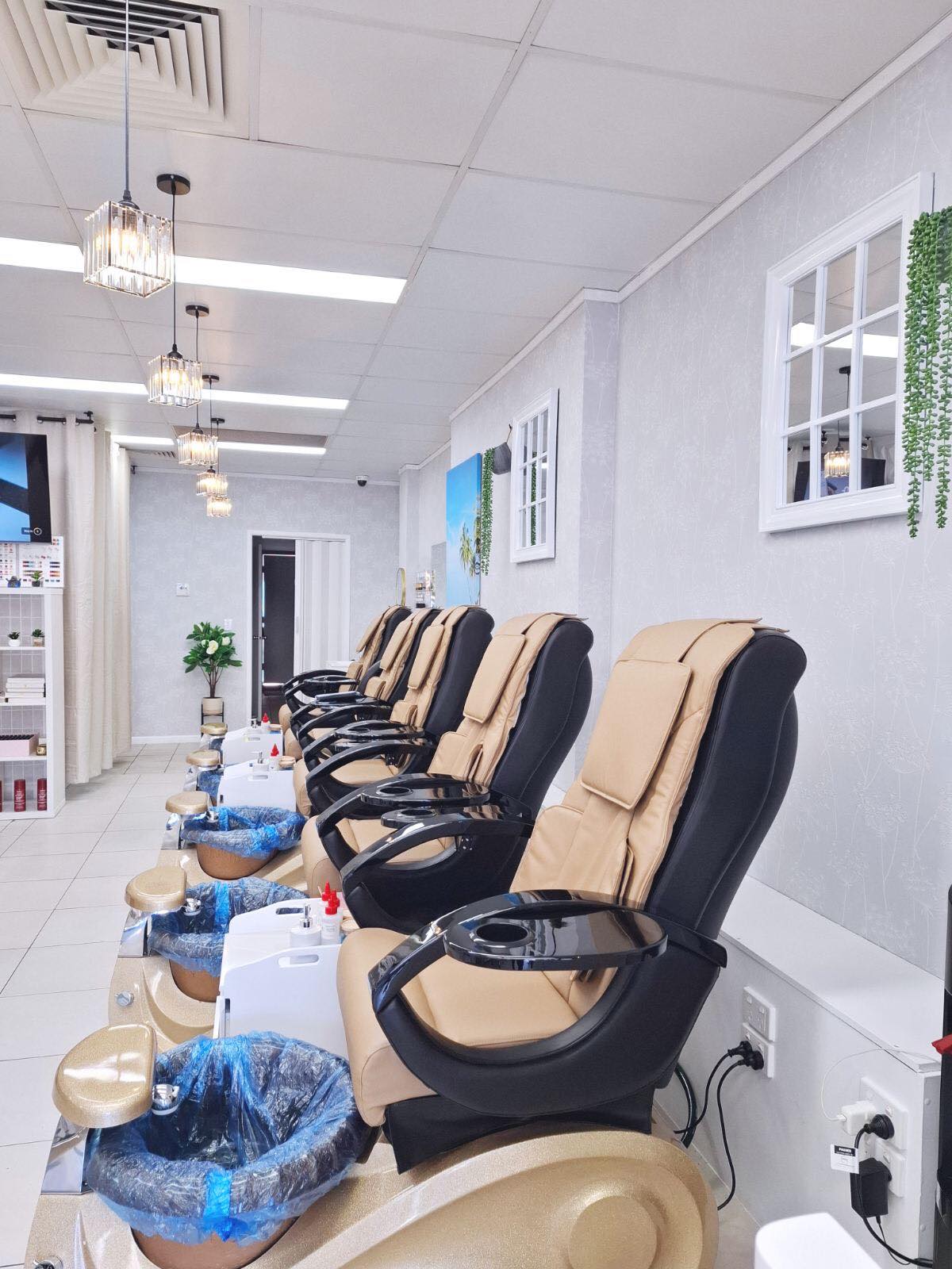 Inside the salon, looking down the row of pedicure chairs